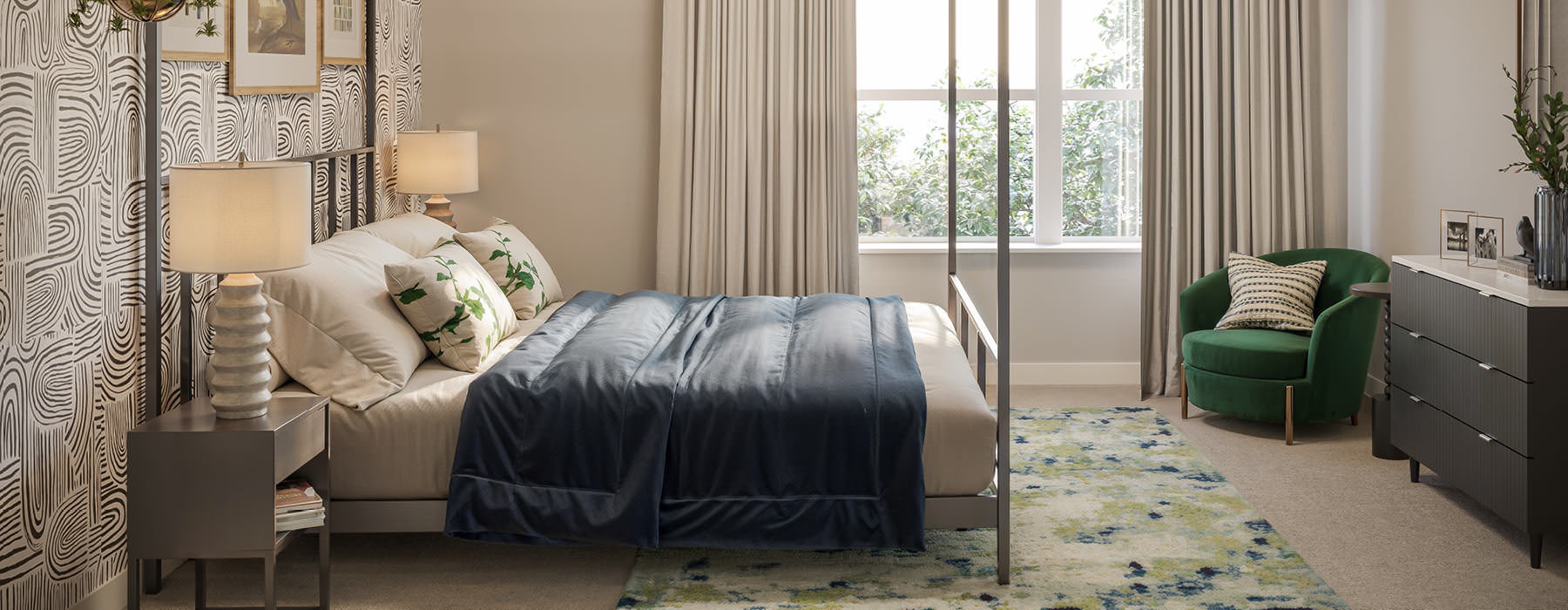 Model bedroom at our apartments for rent in College Park, featuring carpeted flooring and windows with curtains.