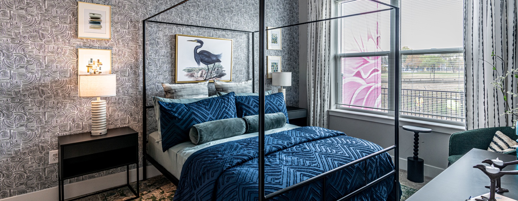 Model bedroom at our apartments for rent in College Park, featuring carpeted flooring and windows with curtains.